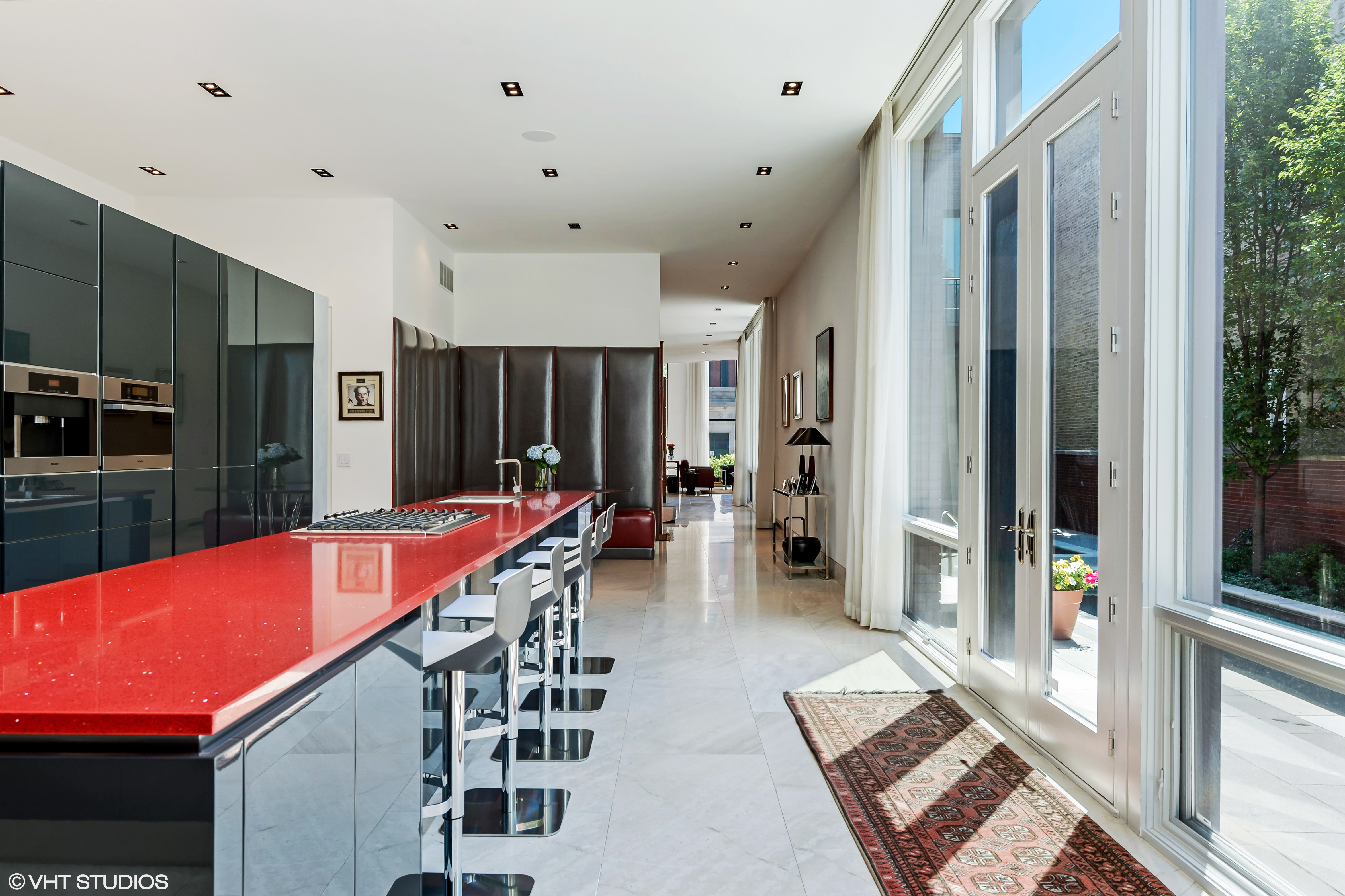 Open plan minimalist kitchen with red counter top